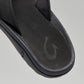 OluKai Men's Ohana black sandal close-up showing footbed and fish hook logo detail