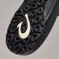 Close-up of OluKai Ohana black sandal outsole with textured tread pattern and cream logo