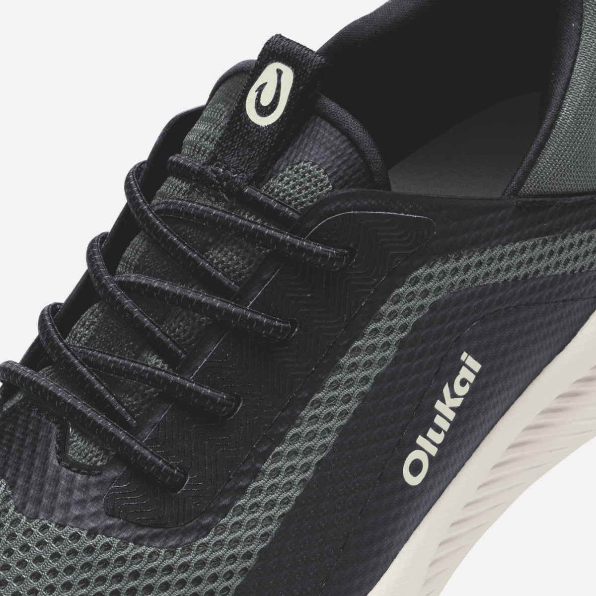 OluKai Men's Kialoa sneaker in Dark Shadow and Lava Rock colorway, close-up view