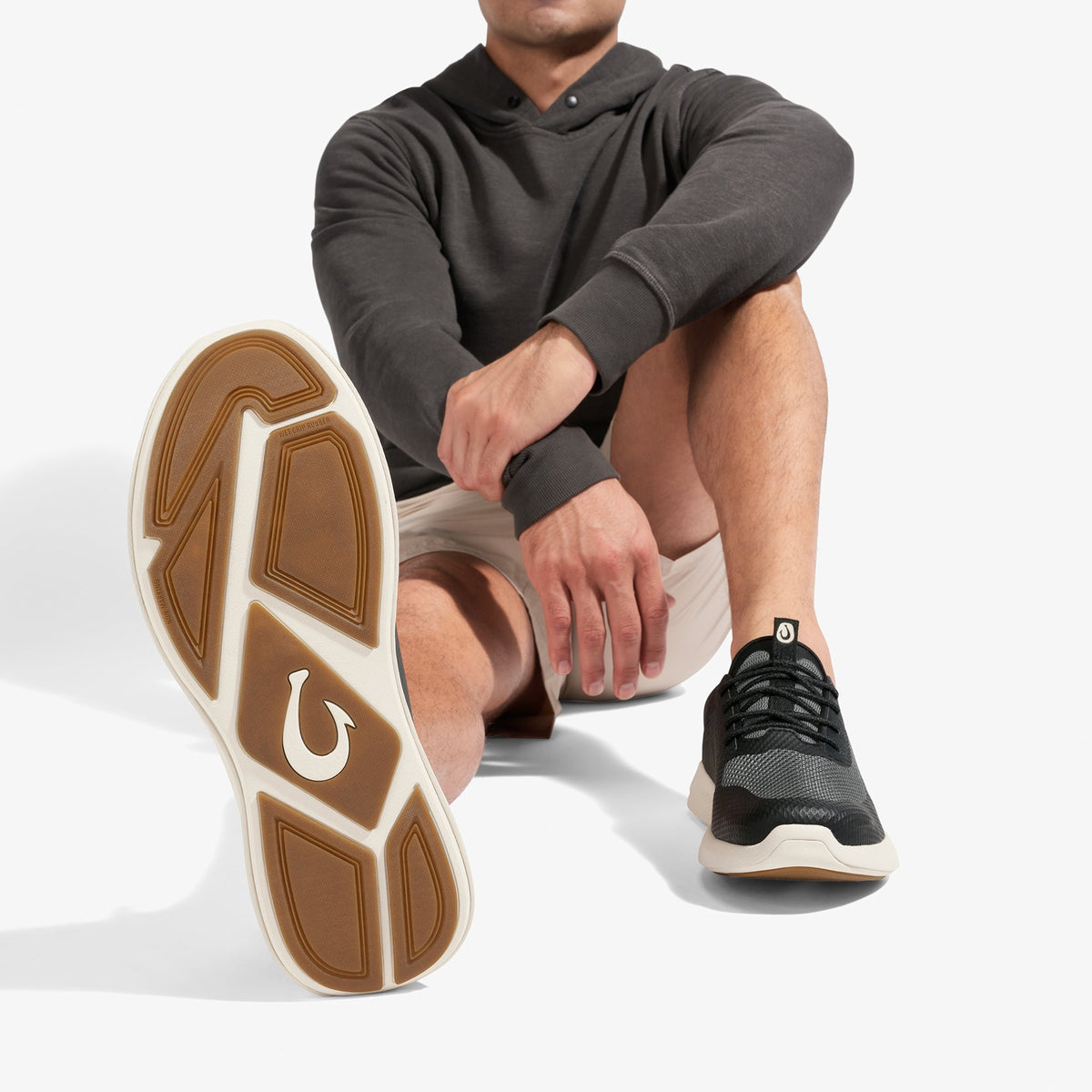 OluKai Kialoa men's sneaker in Dark Shadow Lava Rock colorway, showing sole and upper views