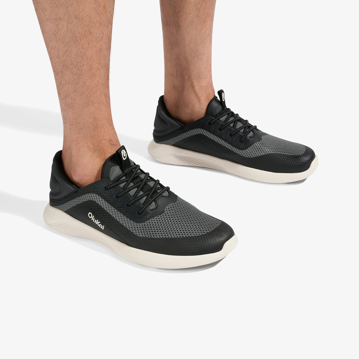 OluKai Men's Kialoa sneaker in Dark Shadow Lava Rock with gray mesh upper and cream sole