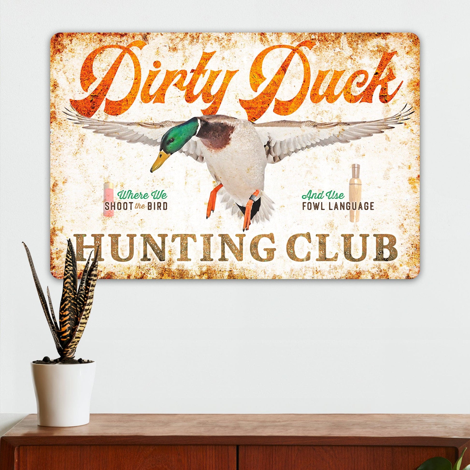 Dirty Duck Hunting Club vintage metal sign with mallard duck, orange script text, and rustic distressed finish