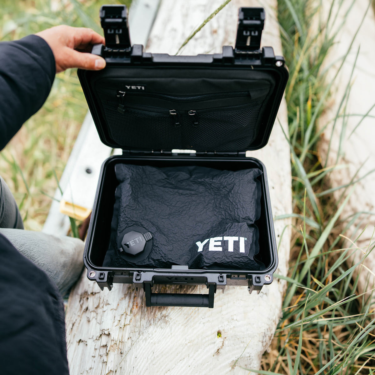 YETI Loadout GoBox 10 open in black showing interior storage compartments and YETI branded bag