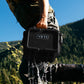 YETI Loadout GoBox 8 in black being lifted from water in outdoor mountain setting