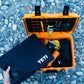 YETI Loadout GoBox KOR protective black inserts being removed from orange rugged case on rocky ground