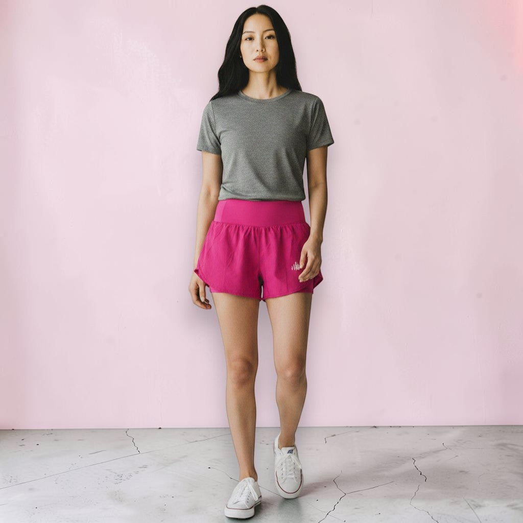 Grace in Motion Short in Berry Pink worn by model with gray tee and white sneakers