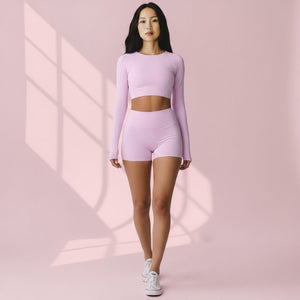 Mercifully Made Short in Light Rose, high-waisted athletic shorts worn with matching crop top and white sneakers