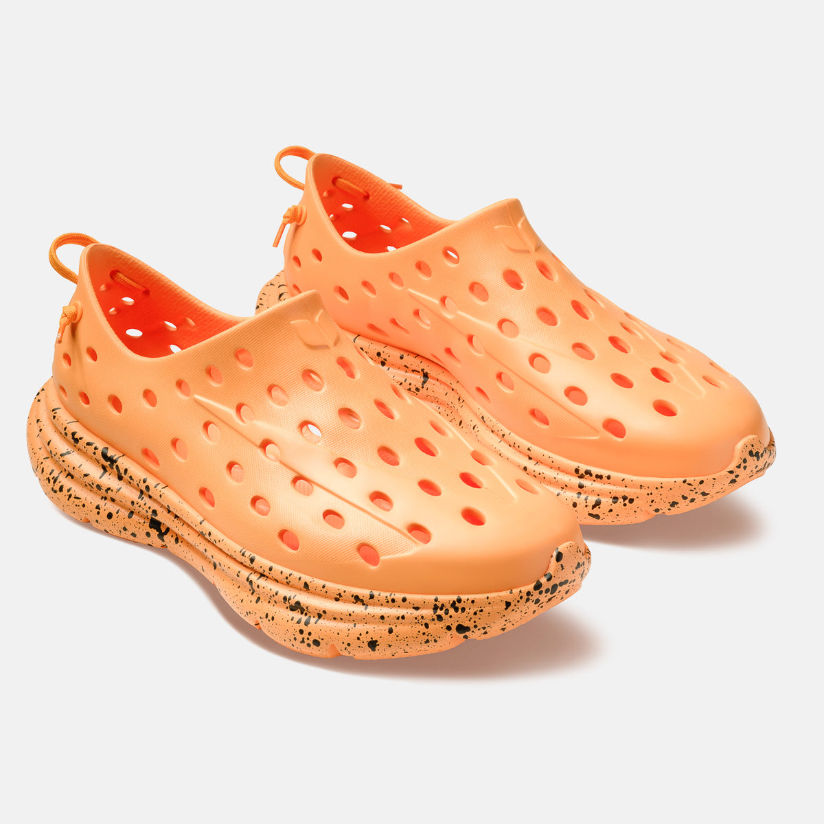 Kane Revive electric orange slip-on shoes with perforated upper and black speckled chunky sole