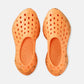 Kane Revive shoes in electric orange with black speckle midsole, top-down view showing ventilation holes