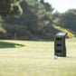 Foresight QC3 launch monitor with Bushnell Pro X3 LINK rangefinder standing on golf course fairway beside white golf ball
