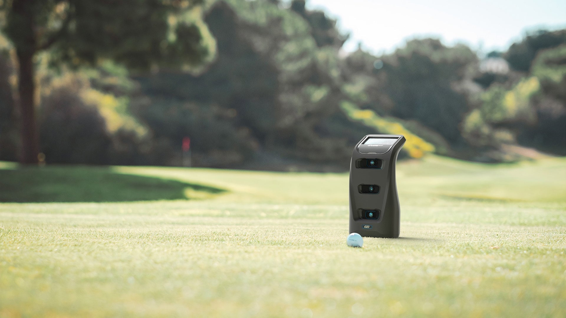 Foresight QC3 launch monitor with Bushnell Pro X3 LINK rangefinder standing on golf course fairway beside white golf ball