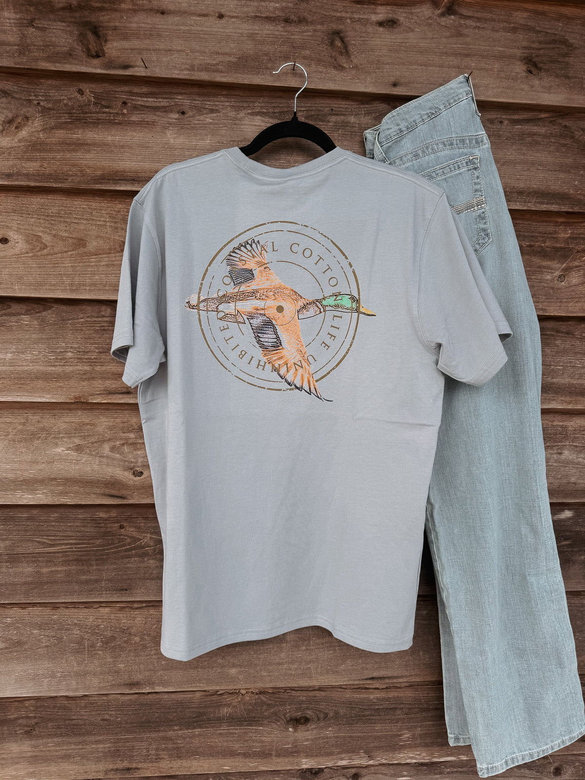 Coastal Cotton Mallard Tradewind Tee back view with flying duck graphic on wooden background