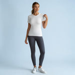 Renewed Strength Active Tee in light white, worn with dark grey leggings and white sneakers