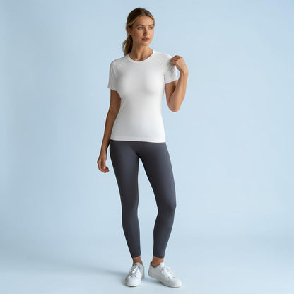 Renewed Strength Active Tee in light white, worn with dark grey leggings and white sneakers