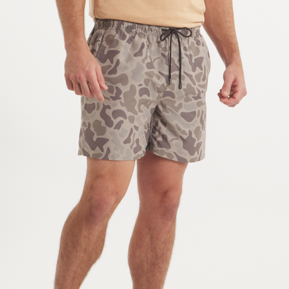 Men's camouflage swim trunks in neutral tan and brown camo pattern with drawstring waistband