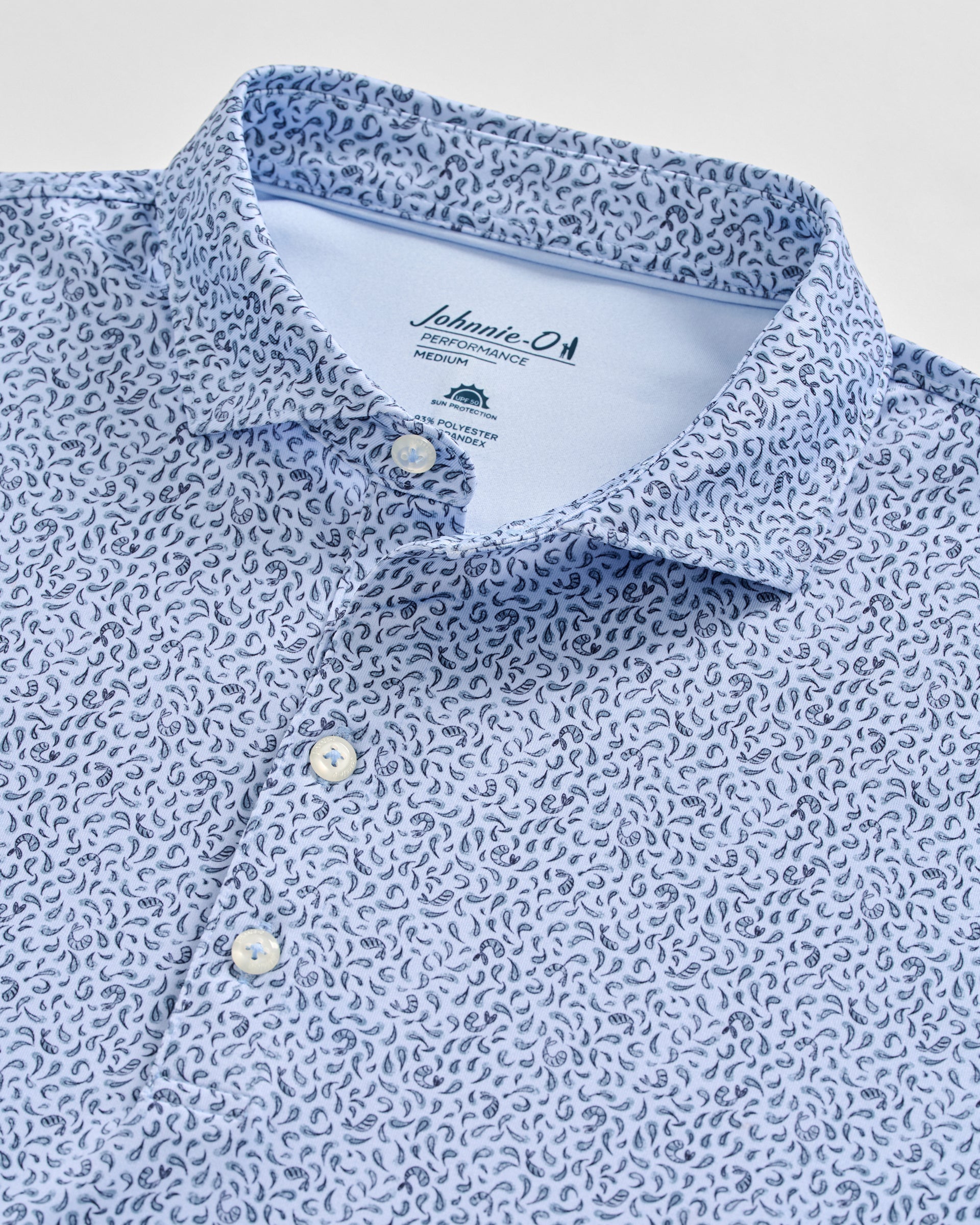 Johnnie-O Prawn Polo shirt in light blue with navy paisley pattern, showing collar and buttons