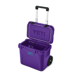 YETI Roadie 32 rolling cooler in Pace Purple with telescoping handle and wheels, open lid