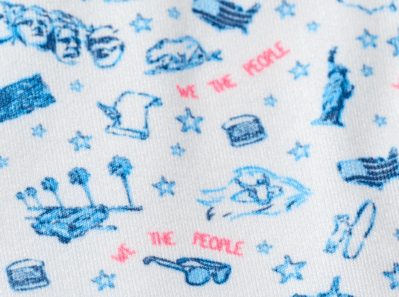 White polo shirt with blue patriotic print featuring Mount Rushmore, eagles, and American symbols